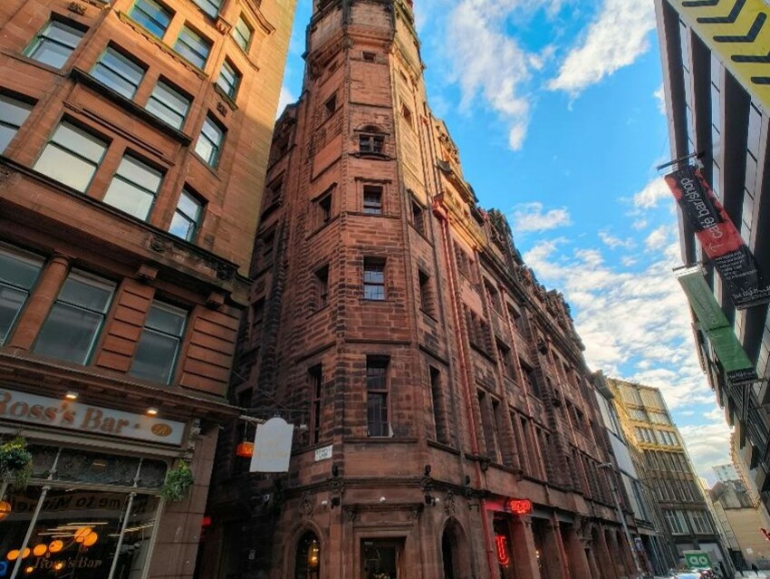 The Lighthouse - a red sandstone building - towers above Mitchell Lane.